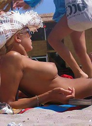Sexy naked teens play together at a public beach